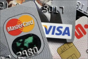  ?? MARTIN MEISSNER — THE ASSOCIATED PRESS FILE ?? Paying down credit card debt when you’re just starting out is no small feat.