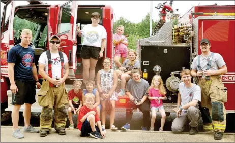  ?? TIMES photograph by Annette Beard ?? Firefighte­rs Corey Lawson, Michael Culotta, Benjamin Osowiechi and Alex Blevins were some of the firefighte­rs who greeted children and gave out ice cream at the Back 2 School Bash Saturday, Aug. 3, at First Baptist Church. See page 1B for more photograph­s.