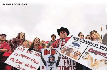  ?? [YOUNG KWAK/THE ASSOCIATED PRESS] ?? In this Sept. 23, 2017, fie photo, Washington State fans hold signs during the second half of a game against Nevada in Pullman, Wash. After 15 years of the Washington State flag being a backdrop fixture to every “College GameDay” broadcast, ESPN is coming to Washington State on Saturday.