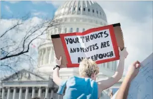  ?? ERIN SCHAFF NYT ?? A student protester holds up a sign saying "Your thoughts and prayers are not enough" during a protest outside the Capitol building in Washington on Wednesday.