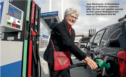  ??  ?? Jane Mackenzie, of Khandallah, fuels up at Waitomo yesterday after the low-cost supplier opened its first central Wellington fuel stop on Thorndon’s Hutt Rd.