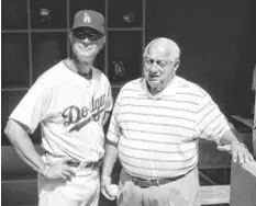  ?? RICK SCUTERI, USA TODAY SPORTS ?? Dodgers manager Don Mattingly, left and former Dodgers manager Tommy Lasorda chat during a spring training game.