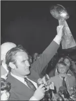  ?? The Associated Press ?? NFL LEGEND: In this Jan. 15, 1973, file photo, Miami Dolphins coach Don Shula waves the Super Bowl trophy for fans as they arrive in Miami after defeating the Washington Redskins in Los Angeles in Super Bowl VII.