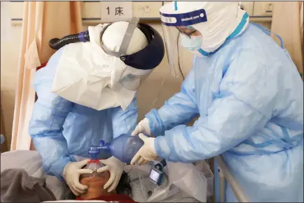  ??  ?? In this Feb 16 photo, medical workers pump oxygen for a new coronaviru­s patient at a hospital in Wuhan in central China’s Hubei province. (AP)