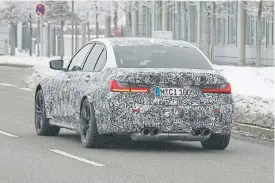  ??  ?? Left: There will reportedly be three versions of the new M3, with different power outputs and two- or allwheel drive. The quad exhausts, right, reveal this to be the new M3 underneath the disguise.