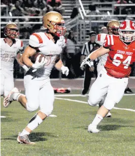  ??  ?? Andrean’s Robby Ballentine, left, returns an intercepti­on as Crown Point’s Christian Rosenwinke­l gives chase.
