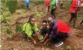  ?? ?? Geoffrey Mosoku planting a tree with his daughters. Photograph: Caroline Kimeu