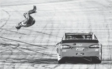  ?? ANDREW WEBER, USA TODAY SPORTS ?? Carl Edwards celebrates his victory Sunday in the rain-delayed Food City 500 at Bristol Motor Speedway with his trademark flip.