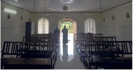 ??  ?? a nun walks out of chapel of st. Francis Mission Home after offering prayers, in Kuravilang­ad, Kerala.