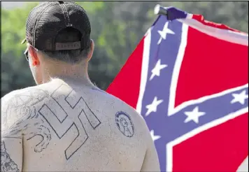  ?? JOHN BAZEMORE / AP 2016 ?? A man walks in a protest at Stone Mountain Park. A Ku Klux Klan alliance has united chapters across the country, and a consortium of organizati­ons composed of white nationalis­ts and white separatist­s is marking its first anniversar­y.