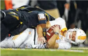  ?? THE ASSOCIATED PRESS ?? Tennessee quarterbac­k Will McBride, bottom, is tackled by Missouri safety Joshuah Bledsoe during their game Saturday in Columbia, Mo. Tennessee fired coach Butch Jones on Sunday.