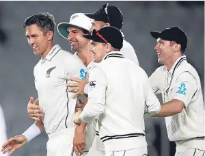  ?? Picture: PA. ?? Trent Boult, left, celebrates with his team-mates after claiming the wicket of Joe Root with the last ball of the fourth day.