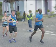  ?? 25_c22mokrun3­7 ?? Footballer Sary Rahma competing in his first MOK Run leads Neil John MacPhail and Fiona Cook.