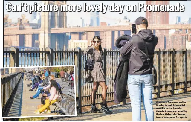  ??  ?? They came from near and far Monday to bask in beautiful sunshine on the Brooklyn Heights Promenade, including Floriane Elkherchi of Rennes, France, who posed for a photo.