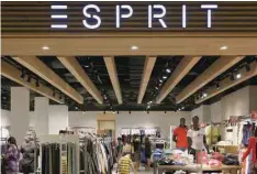  ?? — Reuters ?? People shop at an Esprit Outlet store in Singapore.