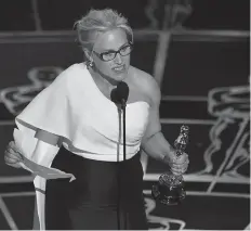  ?? Associated Press ?? ■ In this Feb. 22, 2015, file photo, Patricia Arquette accepts the Oscar for best actress in a supporting role for "Boyhood" in Los Angeles. In her acceptance speech, Arquette took aim at the wage gap and gender equality.