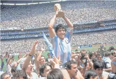  ?? AP ?? Argentina’s Diego Maradona lifts the Fifa trophy in 1986.