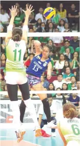  ?? PHOTO BY JOHN MICAH SEBASTIAN ?? La Salle’s Kim Dy soars over Joanna Maraguinot of Ateneo in the University Athletic Associatio­n of the Philippine­s Season 80 women’s volleyball tournament at the Mall of Asia Arena in Pasay City on Saturday.