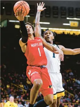  ?? JIM SLOSIAREK/AP ?? Maryland guard Jahmir Young goes to the hoop in front of Iowa guard Ahron Ulis during the first half of Sunday’s game in Iowa City, Iowa.