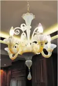  ??  ?? This Murano hand-blown glass chandelier from Venice, Italy, survived the fire.