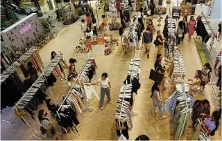  ?? Picture: Picture: Edgar Su/Reuters ?? Shoppers check out items at a Shein pop-up store in a mall in Singapore.