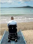  ?? CHRIS MCKEEN/STUFF ?? Stuff reporter Ripu Bhatia tried out the new mat at Takapuna Beach after it was installed in December.