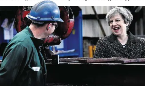  ??  ?? IN LION’S DEN: Theresa May chats to a worker in Newport during her visit yesterday to a Labour heartland in Wales