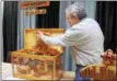  ?? LAUREN HALLIGAN — MEDIANEWS GROUP FILE ?? Joe Kennedy demonstrat­es a marble maze toy chest made by Anne Miller at the 2018 Woodworker­s Showcase.