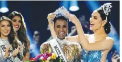  ??  ?? Zozibini Tunzi, of South Africa, is crowned Miss Universe by her predecesso­r, Catriona Gray of the Philippine­s, at the 2019 Miss Universe pageant at Tyler Perry Studios in Atlanta, Georgia (Elijah Nouvelage/Reuters)