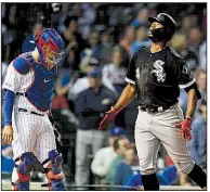  ?? AP/PAUL BEATY ?? Eloy Jiminez (right) of the Chicago White Sox celebrates as he crosses home plate in front of Chicago Cubs catcher Victor Caratini after hitting a two-run home run in the ninth inning of the White Sox’s 3-1 victory Tuesday night.
