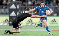  ?? AP ?? France’s Anthony Belleau looks to break the tackle of All Blacks lock Scott Barrett, one of 19 Barrett made during an impressive display.