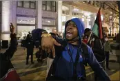  ?? ASHLEE REZIN GARCIA — CHICAGO SUN-TIMES ?? Lamon Reccord leads a chant as dozens of protesters march down the Magnificen­t Mile in Chicago on Thursday evening.