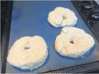  ?? CONTRIBUTE­D ?? After removing the bagels from the boiling water, cover with an egg wash then dip in a favourite topping, such as sesame seeds. Place on a lined cookie sheet to bake.