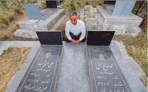  ?? AFP PIC ?? An Iranian Kurdish man visiting the tombs of those killed in a chemical attack during the Iran-Iraq war, in Sardasht in Iran’s West Azerbaijan Province last week.