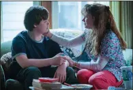  ??  ?? The young J.D. Vance (Owen Asztalos) is alternatel­y comforted and abused by his bipolar mother, Bev (Amy Adams), in “Hillbilly Elegy.”