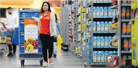  ?? JULIO CORTEZ/AP ?? Walmart’s lower prices helped boost its market share.