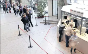  ?? PHOTO: BLOOMBERG ?? Visitors get informatio­n at counters at the Federal Office of Employment in Nuremberg, Germany. The German government released its unemployme­nt figures this week. Seasonally adjusted jobless total dropped by 22 000 to 2.393 million.