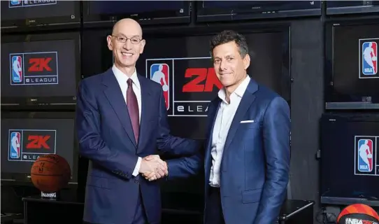  ?? Jenn Pottheiser / NBA via AP ?? NBA commission­er Adam Silver, left, and Take-Two CEO Strauss Zelnick shake on the “NBA 2keLeague.”