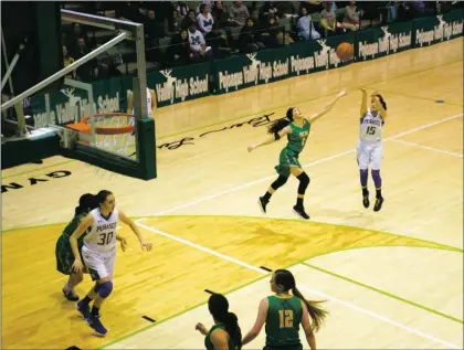  ?? Sheila Miller/ The Taos News ?? Adrianna Tafoya of the Peñasco Lady Panthers put the ball up for three during the third quarter of the Northern Rio Grande Tournament final. Pecos took the first-place trophy with a final score of 57-54.