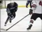  ?? JON BEHM - THE MORNING JOURNAL ?? Benedictin­e sophomore Matt Carson (13) skates Parma’s Robbie Gudin during an Brooklyn District first-round game on Feb. 15.