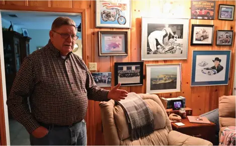  ?? Staff photo by Hunt Mercier ?? ■ Frank Lance talks about working for Ford and competing against Ferrari in his living room decorated with racing memorabili­a and photos in Queen City, Texas. Lance worked on Ford GT's and Shelby Cobras during the 1960s.