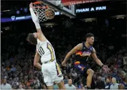  ?? MATT YORK — THE ASSOCIATED PRESS ?? New Orleans Pelicans center Jaxson Hayes (10) dunks as Phoenix Suns guard Devin Booker (1) defends during Game 2, Tuesday, in Phoenix.