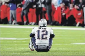  ?? ROB CARR GETTY IMAGES ?? Tom Brady sits dejectedly after giving up a decisive fumble late in the fourth quarter of Sunday’s Super Bowl.