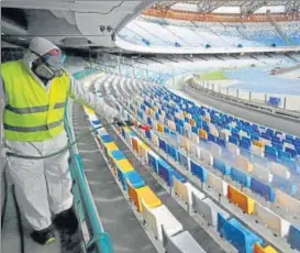  ?? REUTERS ?? ■
A cleaner wearing a protective suit sanitises seats at the San Paolo stadium ahead of the second leg of the Coppa Italia semi-final between Napoli and Inter Milan, which has since been postponed as part of measures to contain the coronaviru­s outbreak, in Naples, Italy, on Wednesday.