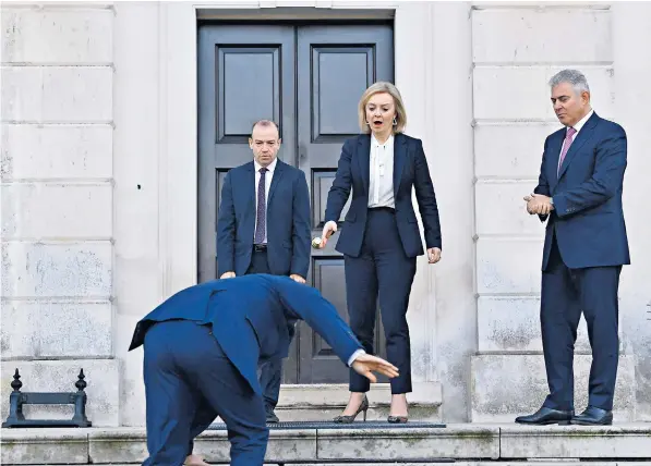  ?? ?? Liz Truss, the Foreign Secretary, is alarmed to see Maros Sefcovic, the European Commission vice-president, slip on an icy step ahead of their meeting at Chevening House in Sevenoaks, Kent, yesterday