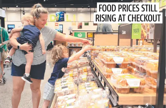  ?? Picture: Brendan Radke ?? Naomie Mills shops with Harlyn, 4, and Jai, 2, at the Woolworths store in Gubuda Gordonvale in Queensland.