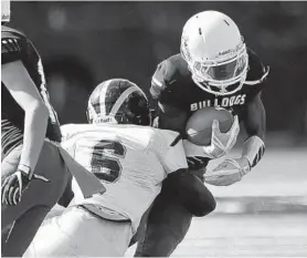  ?? MATTHEW COLE/BALTIMORE SUN MEDIA GROUP ?? Potomac’s Donta Anthony Jr., tackling Bowie’s Ramont Baldwin in a game last fall, will play tight end for Team Maryland in tonight’s Big 33 Classic.