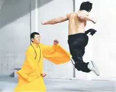  ??  ?? Philip Ng, playing the role of Bruce Lee, goes airborne in the encounter with Shaolin master Wong Jack Man.