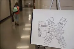  ??  ?? ■ Arkansas Middle School students have their temperatur­e taken upon entering the building on the first day at their new school on Monday morning.