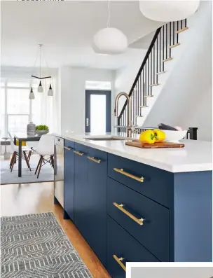  ??  ?? ABOVE, LEFT &amp; RIGHT The kitchen is a beautiful balance of colours and materials – as well as the requests of each homeowner. One wanted brass while the other favoured stainless steel (hence the hardware mix), and while both wanted finishes in walnut and white, one really wanted blue. “Luckily, I managed to find the perfect backsplash tiles to pull it all together,” says Orsi.